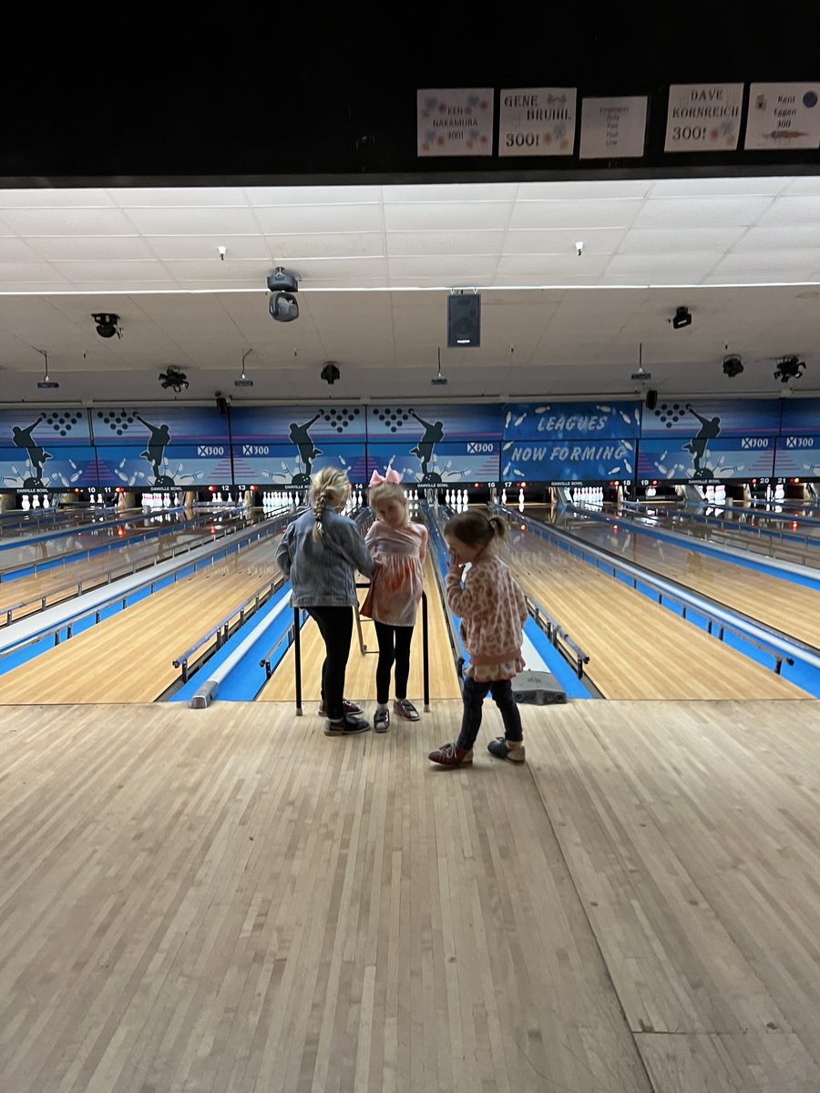 Kids having fun at the bowling lanes during family bowling night