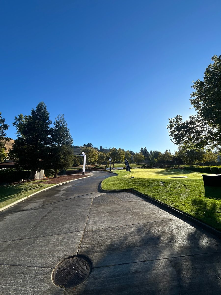 Blackhawk Country Club entrance with event banners on a blue-sky morning