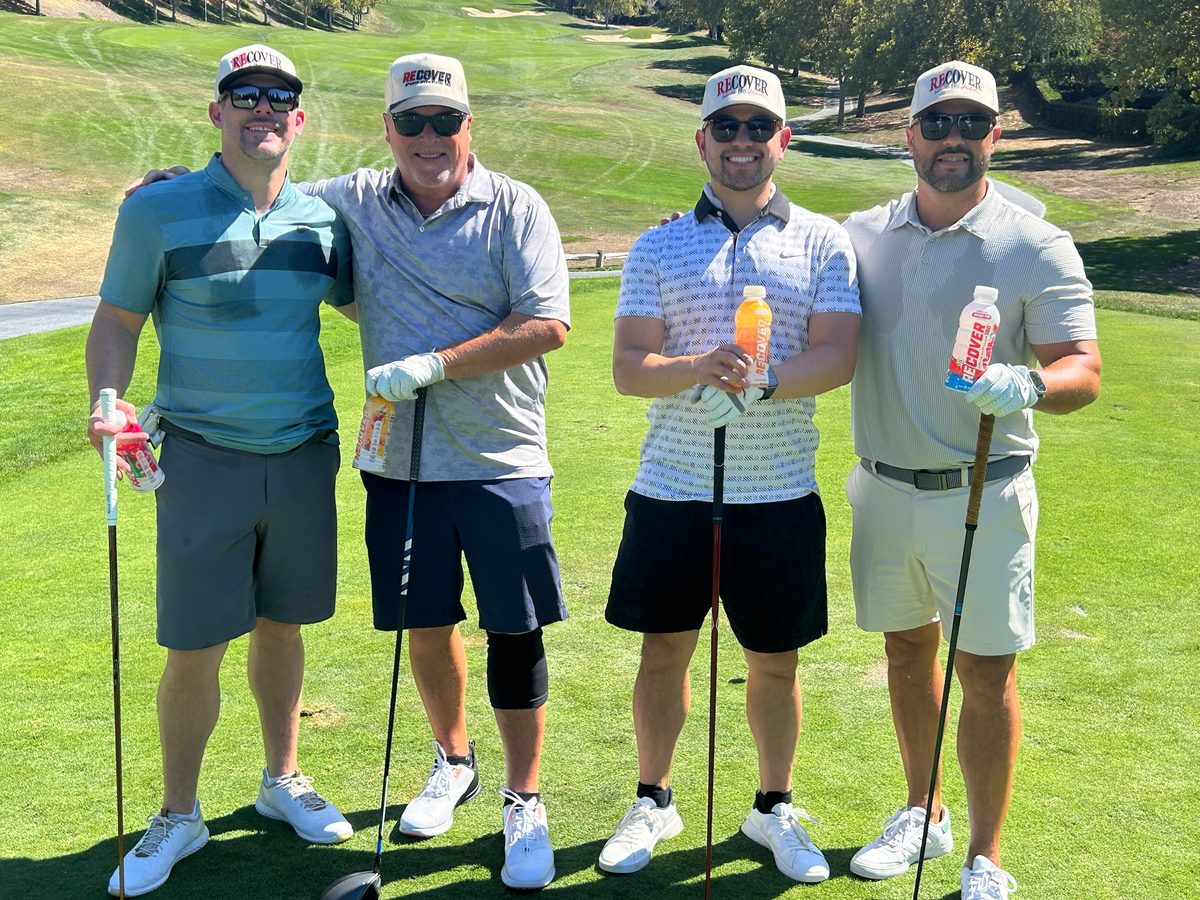 Foursome on the fairway with East Bay hills in the distance