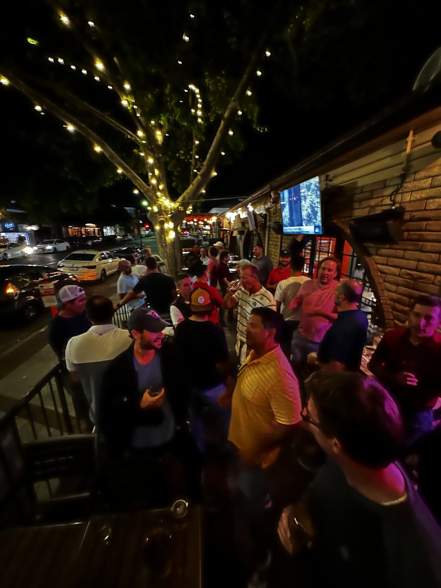Outdoor evening gathering with string lights