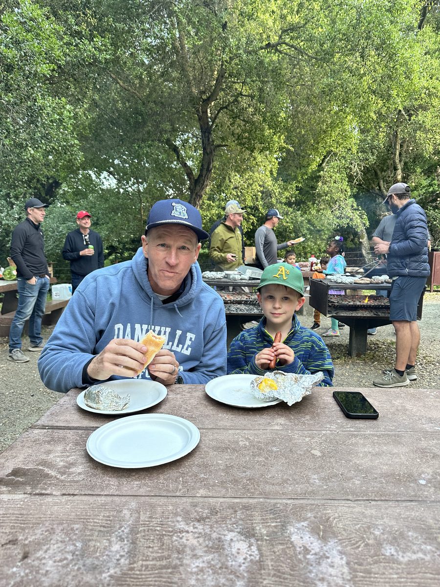 Dad and kid at a picnic table in the park
