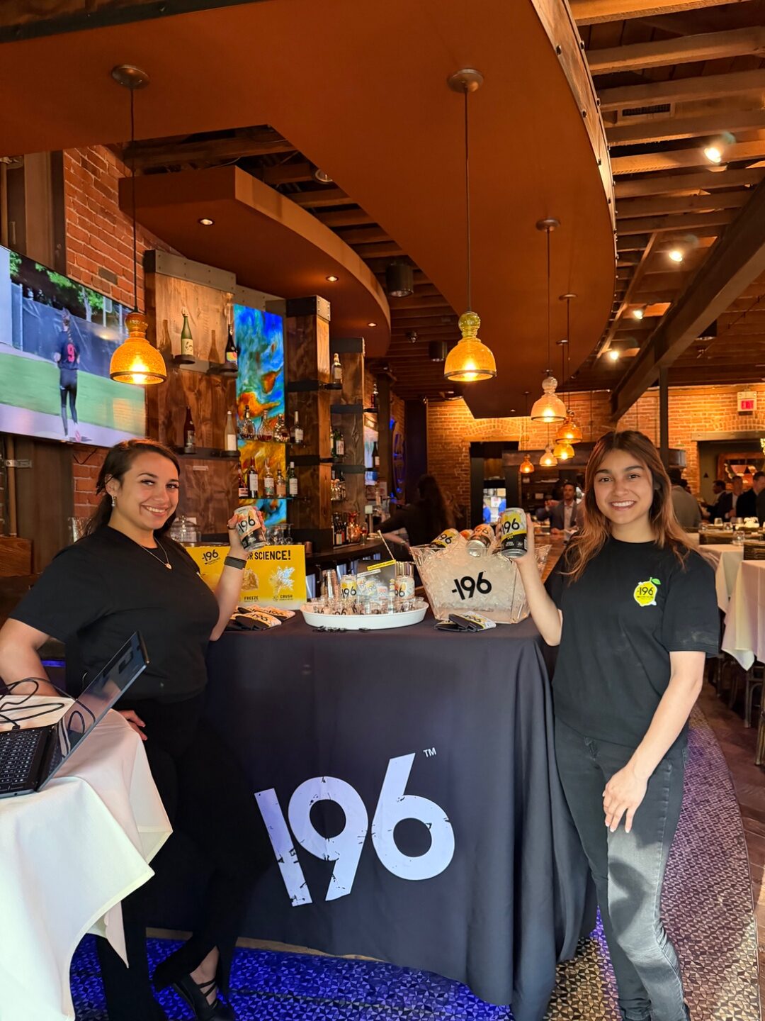 Two -196 Suntory brand ambassadors with the sponsor table at TLEg 2 happy hour