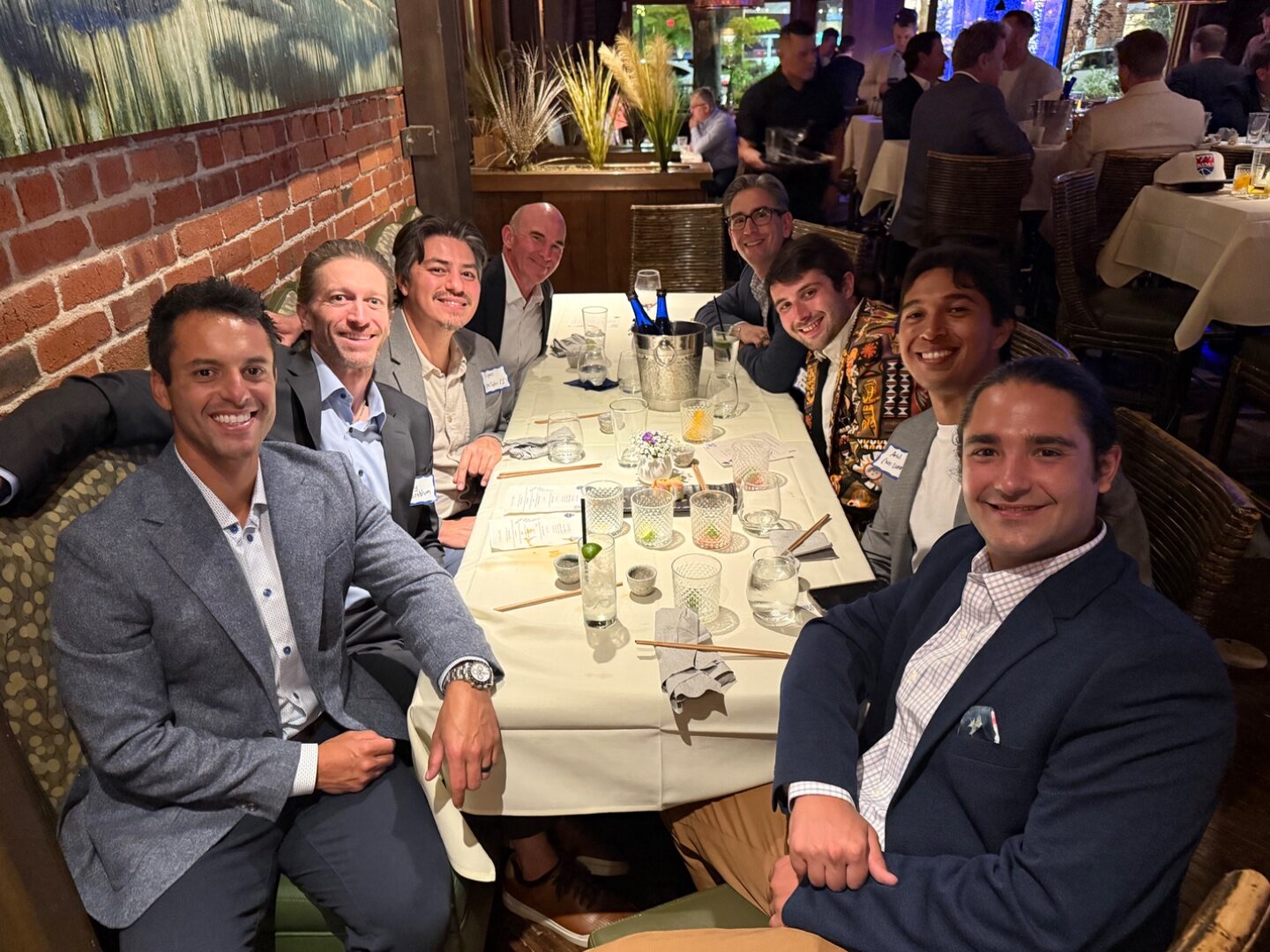 Group of dads at the head of the table sharing a toast at TLEg 2
