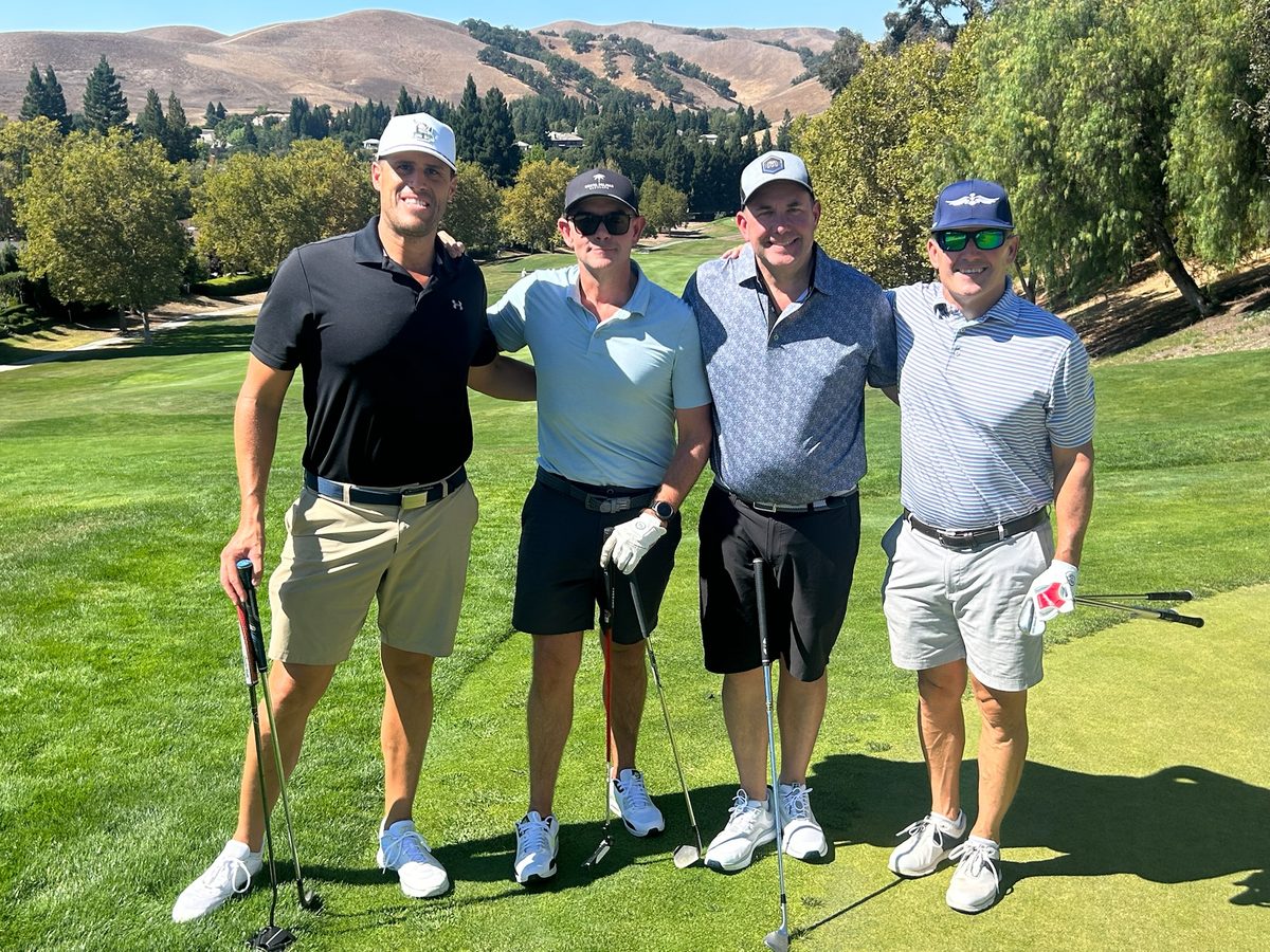 Foursome on the fairway with Blackhawk hills in the background