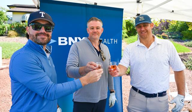 Cheers at the BNY Wealth tent, 2026 SIS Golf Classic