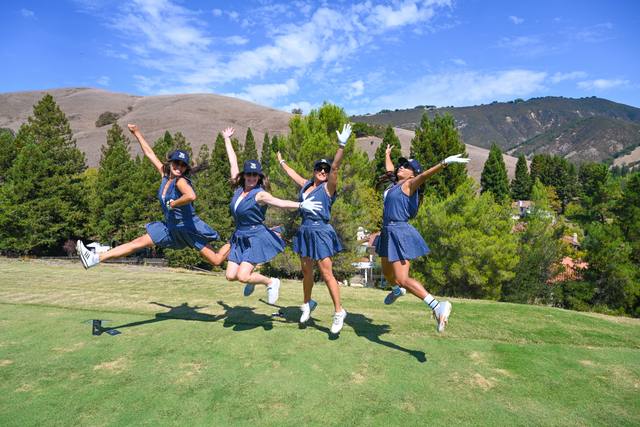 Foursome jumping on the fairway, 2026 SIS Golf Classic