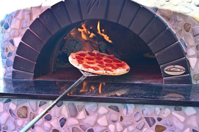 Wood fired pizza coming out of the oven, 2026 SIS Golf Classic